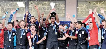  ??  ?? SAN JOSE: US footballer­s celebrate with the trophy after winning the U-20 Concacaf final football match against Honduras at the National stadium in San Jose on Sunday. — AFP