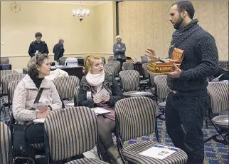  ?? PHOTO BY LAYNE LITSINGER/CAPITAL NEWS SERVICE ?? Alex Hempfield, who changed his last name from Joseph, shares his hemp nutritiona­l bars with forum attendees at an Abell Foundation Hemp forum on Friday, Feb. 2, in Annapolis. Hempfield started his own hemp product business in 2011, specifical­ly known...