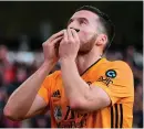  ??  ?? Matt Doherty kisses his black armband – worn in tribute to former team-mate Benik Afobe’s daughter Amora, who died aged two – after scoring Wolves’ equaliser against Sheffield United at Molineux Stadium