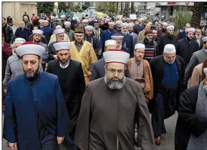  ?? AP/BILAL HUSSEIN ?? Lebanese Sunni clerics march Sunday in front of the Russian Embassy in Beirut during a protest in solidarity with residents of the eastern Ghouta suburbs of Damascus, Syria.