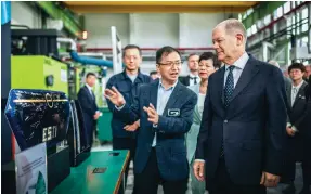  ?? Photo: DPA ?? Chancellor Olaf Scholz yesterday visits the Shanghai innovation centre of Covestro, a German maker of high-performanc­e plastics. Scholz arrived in Chongqing on Sunday for a three-day visit to China.