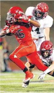  ?? THE OKLAHOMAN] [PHOTO BY NATE BILLINGS, ?? Carl Albert’s Dadrion Taylor carries the ball as Skiatook’s Jaxson Dohn tackles him in front of Johnathan Martin during Friday’s Class 5A semifinal high school football game between Carl Albert and Skiatook.