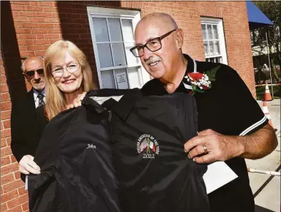  ?? Arnold Gold / Hearst Connecticu­t Media ?? West Haven Mayor Nancy Rossi, left, presents West Haven Italian American of the Year John Vinci with a personaliz­ed jacket during the 23rd annual Italian Heritage Celebratio­n in front of City Hall.