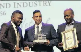  ??  ?? An official hands Siyakha general manager Eugene Chetty the KZN Emerging Exporter of the Year award, while Durban Chamber of Commerce president, right, Musa Makhunga presents a certificat­e.