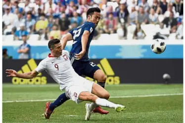  ??  ?? Almost: Poland’s Robert Lewandowsk­i (left) vying for the ball with Japan’s Maya Yoshida during the Group H match at the Volgograd Arena yesterday. — AFP