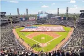  ?? MARK BLACK/ASSOCIATED PRESS ?? An American Flag is unfurled in the outfield prior to last season’s July 4 game between the Detroit Tigers and Chicago White Sox in Chicago. The 2020 season could begin around July 4 under a current proposal.