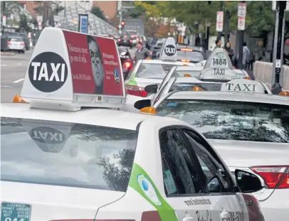  ?? JIM MICHAUD/ BOSTON HERALD ?? AT A LOSS: Taxi medallions aren’t worth nearly what they used to be just a few years ago, as ridership declines and more people are turning to ride-hailing services such as Uber and Lyft.