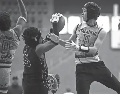  ?? ?? Andrew Greve, right, reaches for the ball during a 7-on-7 football tournament last weekend at the UNI-Dome in Cedar Falls.