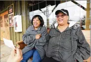  ?? HYOSUB SHIN / HYOSUB.SHIN@AJC.COM ?? Twin sisters Prissy (left) and Patty Moses are presented with a donation check in Norcross last week. Readers were touched by the recent AJC feature about the Moses’ foster parenting and their financial struggles and responded generously.