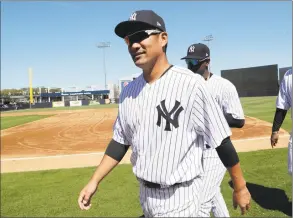  ?? Lynne Sladky / Associated Press ?? Yankees pitcher Masahiro Tanaka walks to the dugout before a spring training game in Febraury. Tanaka will start on opening date on March 28 against the Orioles.