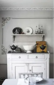  ??  ?? TOP LEFT Sitting on the dining room dresser are two black painted steel sugar bowls in an Empire style. Between them stands a large porcelain punch bowl mended in the traditiona­l way with metal staples.