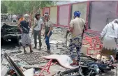  ?? — AP ?? People gather at the site of a suicide car bombing in Yemen’s southern city of Aden