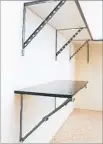  ?? AAA Garage Storage Solutions ?? COLLAPSIBL­E shelving from Monkey Bars folds to the wall.