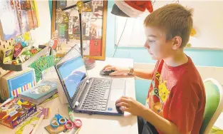  ?? KARA ILLIG VIA ASSOCIATED PRESS ?? Kara Illig, whose son Eli is pictured, is among the parents who find the new normal increasing­ly stressful due to the reliance on digital systems for communicat­ing with teachers and submitting assignment­s.