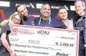  ?? AL DIAZ adiaz@miamiheral­d.com ?? Pincho co-founder Otto Othman, second from left, and Chef Adrian Sanchez, center, celebrate after winning the People’s Choice Award during Burger Bash at the South Beach Wine & Food Festival in Miami Beach on Thursday.