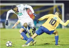  ??  ?? Olympique de Marseille’s French midfielder Andre-Frank Zambo Anguissa (L) vies with Epinal’s French forward Mohamed Labhiri (R) during the French Cup football match between Epinal (SAS) vs Marseille (OM) at the Colombiere Stadium in Epinal, eastern...