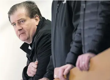  ?? — THE CANADIAN PRESS FILES ?? Vancouver Canucks general manager Jim Benning watches the NHL hockey team practice in Vancouver, last year.