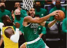  ?? Michael Dwyer / Associated Press ?? Jayson Tatum had 37 points and 11 rebounds in Boston’s win. LeBron James had 23 points in his return from injury.