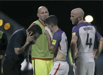  ?? Rebecca Blackwell/Associated Press ?? Reality sets in for Christian Pulisic, center, and Michael Bradley, right, after losing to Trinidad and Tobago, 2-1, Tuesday night in Couva, Trinidad.