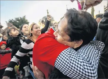  ??  ?? TIRZA VALENZUELA Esquivel, right, hugs her son Everardo Valenzuela after 20 years apart. The process to apply for a tourist visa can be long and complicate­d, especially for older people from rural towns.