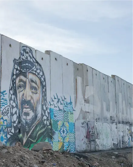  ?? CHRIS MCGRATH/ GETTY IMAGES ?? A painted mural of Yasser Arafat on wall in Ramallah, West Bank.