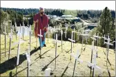  ?? ELIAS FUNEZ — THE UNION ?? On Tuesday Lola Gold of the Jewish congregati­on B’nai Harim walks through the COVID Memorial placed along the Golden Center Freeway in Grass Valley.