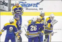  ?? / MILWAUKEE JOURNAL SENTINEL ?? University School team members react after the Wildcats lose, 6-0, to Appleton United in a quarterfin­al game Thursday.