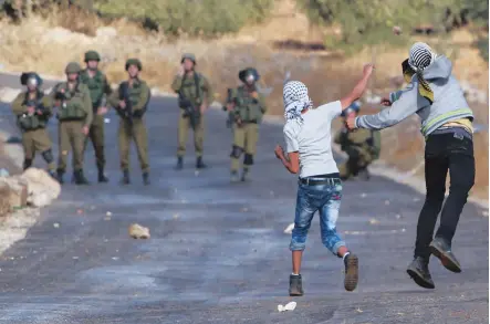  ??  ?? Palestinia­n protesters and Israeli security forces clash in the West Bank village of Tuqua, south- east of Bethlehem,, on Thursday.