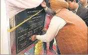  ?? ANI FILE ?? Punjab minister SS Randhawa covers Congress leaders’ names with black tape to avoid sharing space with Akalis on the foundation stone of the Kartarpur corridor project in Gurdaspur.