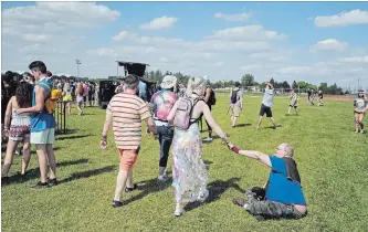  ?? DAVID BEBEE WATERLOO REGION RECORD ?? Ever After festivalgo­ers greet each other outside the gates at Bingemans on Friday.