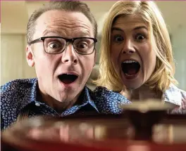  ??  ?? Wheel of fortune: Simon Pegg and Rosamund Pike search for happiness