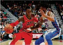  ?? KEVIN C. COX / GETTY IMAGES ?? Dennis Schroder (left, driving on Detroit’s Reggie Bullock) led the Hawks with 23 points — including six clutch free throws late — and seven assists.