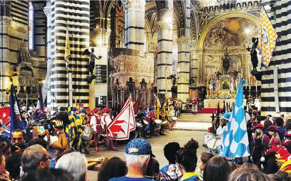  ?? PHOTOS: RICK STEVES ?? Representa­tives of Siena’s neighbourh­oods, each with their own colourful costumes and banners, gather at the cathedral.