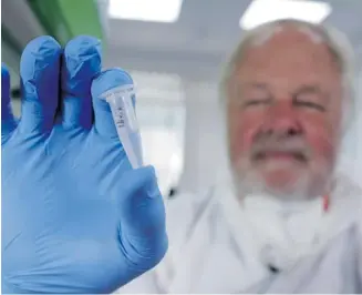  ?? Channel 4/The Associated Press ?? Oxford University genetics professor Bryan Sykes shows a prepared DNA sample taken from hair from a Himalayan animal believed to be linked to the elusive ape-like yeti.