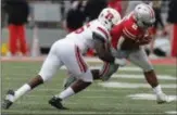  ?? JAY LAPRETE — THE ASSOCIATED PRESS ?? Rutgers linebacker Rashawn Battle, left, tries to tackle Ohio State running back J.K. Dobbins during last week’s game.