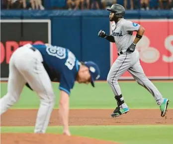  ?? JULIO AGUILAR/GETTY ?? Miami’s Bryan De La Cruz runs the bases after hitting a home run off Tampa Bay’s Calvin Faucher in the fifth inning at Tropicana Field on Wednesday.