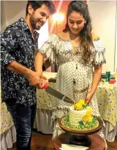  ?? — PTI ?? Actor Shahid Kapoor with his wife Mira Rajput cuts a cake at her baby shower ceremony, in Mumbai on Sunday.