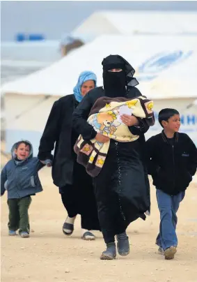  ??  ?? Human catastroph­e Syrian refugees fled their homes with few possession­s