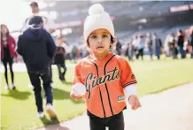  ??  ?? Zariah Patel, 11⁄2 years old, led the league in cuteness while holding a baseball on the Oracle Park field Saturday.