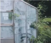  ??  ?? Messages scrawled on the greenhouse at Achamore gardens.