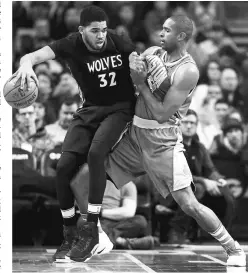  ??  ?? Minnesota Timberwolv­es centre Karl-Anthony Towns defended by Boston Celtics forward Al Horford (right) during the third quarter at TD Garden. — USA TODAY Sports