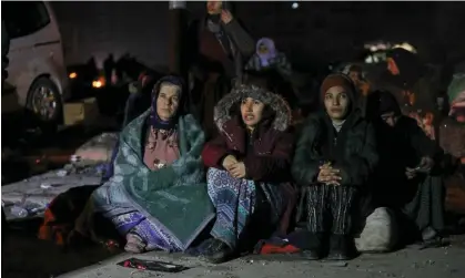  ?? Photograph:Tunahan Turhan/Sopa/Rex/Shuttersto­ck ?? People wait in the earthquake zone as rescuers work to free others from the rubble.