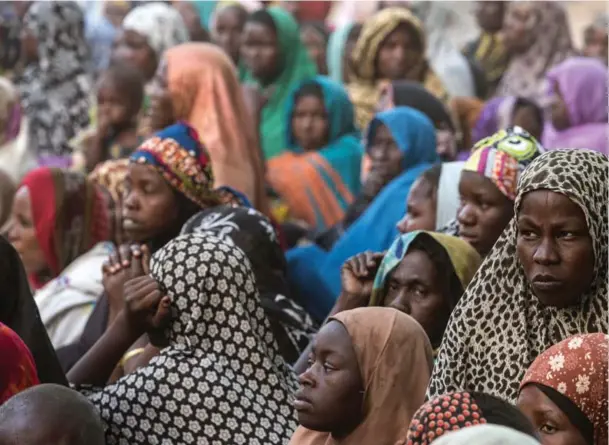  ??  ?? Civilians gather at a makeshift camp for displaced people on the outskirts of Maiduguri, Borno, one of the poorest and least developed states of Nigeria — and the birthplace of Boko Haram.