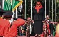  ?? AFP via Getty Images ?? Tanzanian President Samia Suluhu Hassan inspects a military parade after she was sworn in Friday in Dar es Salaam.