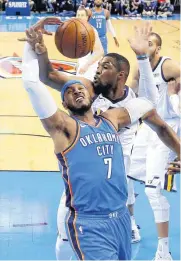  ??  ?? Oklahoma City’s Carmelo Anthony (7) fights for the ball with Utah’s Derrick Favors during Game 5 of a first-round NBA playoff series Wednesday at Chesapeake Energy Arena.