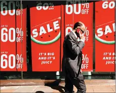  ?? LUKE MACGREGOR/BLOOMBERG NEWS 2018 ?? A man passes sale signs in the window of a NewLook store in Oxford Street in London.
