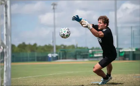  ?? SUBMITTED PHOTO — COURTESY OF PHILADELPH­IA UNION ?? Union goalkeeper Joe Bendik stops a shot at training in Orlando on Monday. Bendik, like many other MLS players, has had to leave behind his family for a month or more to take part in the MLS Is Back Tournament.