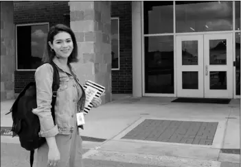  ?? ACACIA CORONADO/REPORT FOR AMERICA VIA AP ?? First-year teacher Cindy Hipps stands outside of Lagos Elementary School, at Manor Independen­t School District campus east of Austin, Texas where she has taught first grade in a virtual and in-person hybrid classroom during the COVID-19 pandemic. Hipps said she was told she “was introduced to the ring of fire of teaching.” “I feel like a superwoman now, like I can take on anything.”