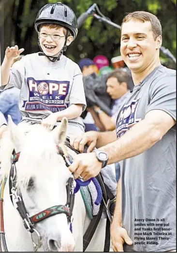  ??  ?? Avery Owen is all smiles with new pal and Yanks first baseman Mark Teixeira at Flying Manes Therapeuti­c Riding.