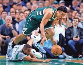  ?? WINSLOW TOWNSON / USA TODAY SPORTS ?? Bucks guard Malcolm Brogdon goes for a loose ball over Celtics guard Avery Bradley.